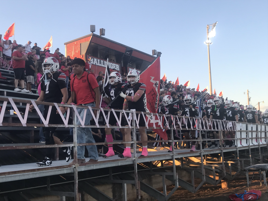 The Ballinger Bearcats walk through the home stands before their game against the Bangs Dragons on Friday, Oct. 10, 2025.