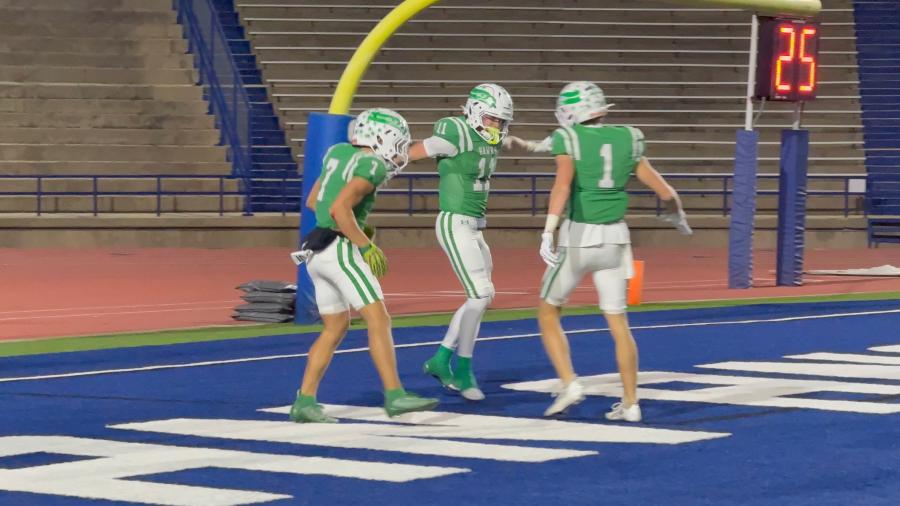 Wall's Evan Boehle (11), Jager Thompson (7) and Reid Robertson (1) celebrate after a touchdown against Idalou in the regional final at San Angelo Stadium on Friday, Dec. 5, 2025.