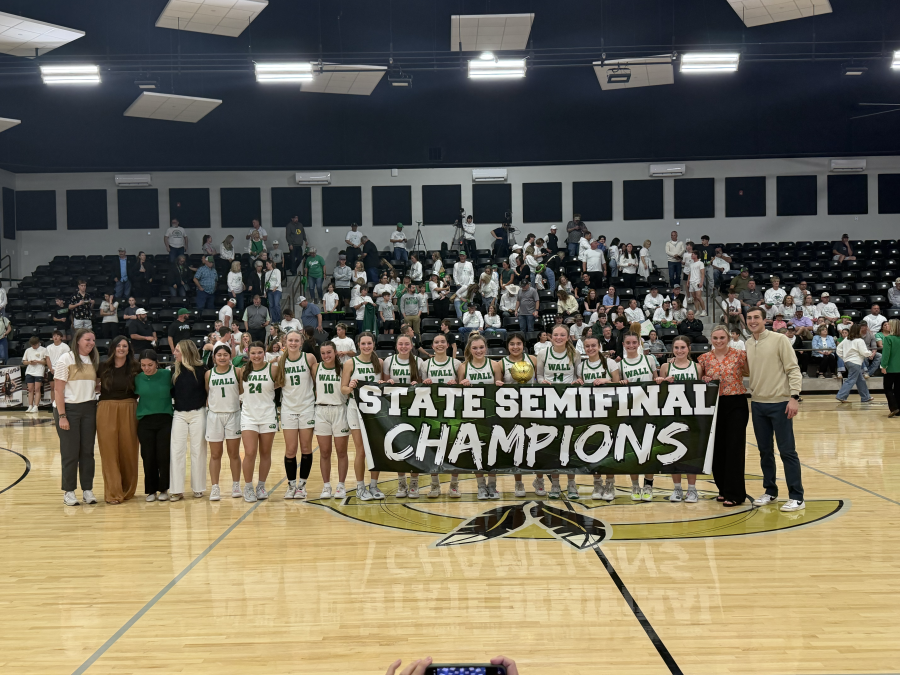 The Wall girls basketball team celebrates with its state semifinal banner after its 54-51 win over Paradise on Tuesday, March 3, 2026.