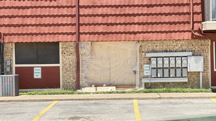 Damage to an apartment building off Sweetbriar Drive after a vehicle crash.