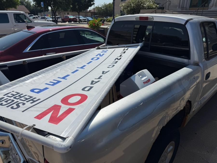 A sign advertising the recall petition of Mayor Tom Thompson in the back of Richard Summers' rusty, old Dodge pickup. He drove to city hall to deliver only 2/3s the petitions required to recall Mayor Tom Thompson.