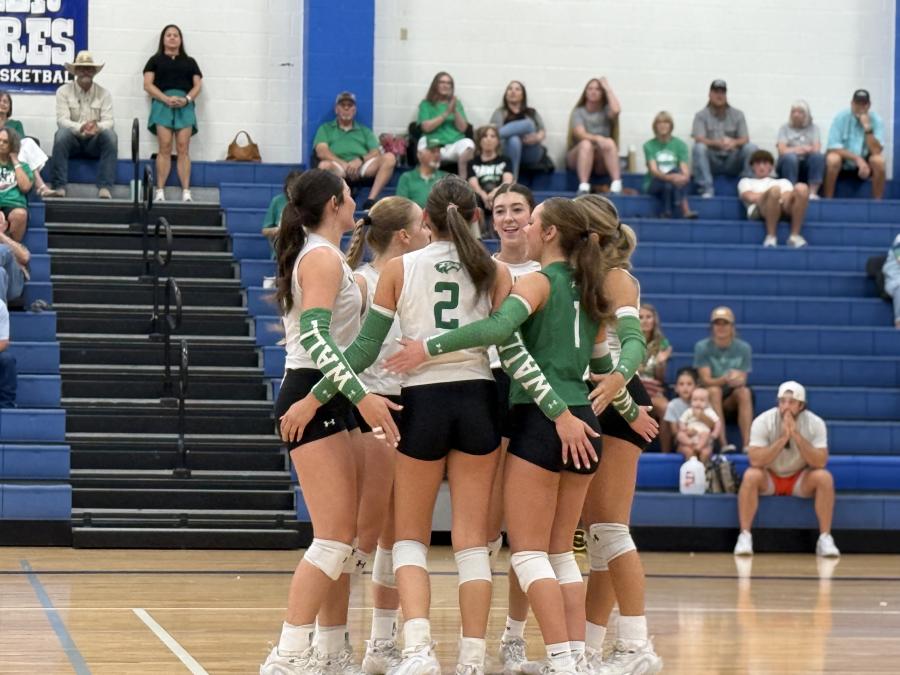 The Wall volleyball team celebrates after a point during the 2026 Nita Vannoy Memorial Tournament.