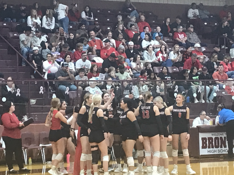 The Ballinger volleyball team talks during a timeout in front of its fans at the Lady Cats' first-round playoff match against Colorado City on Thursday, Oct. 29, 2026.