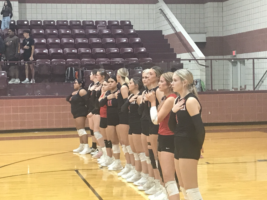 The Ballinger volleyball team stands for the national anthem before its first-round playoff match against Colorado City on Thursday, Oct. 29, 2026.