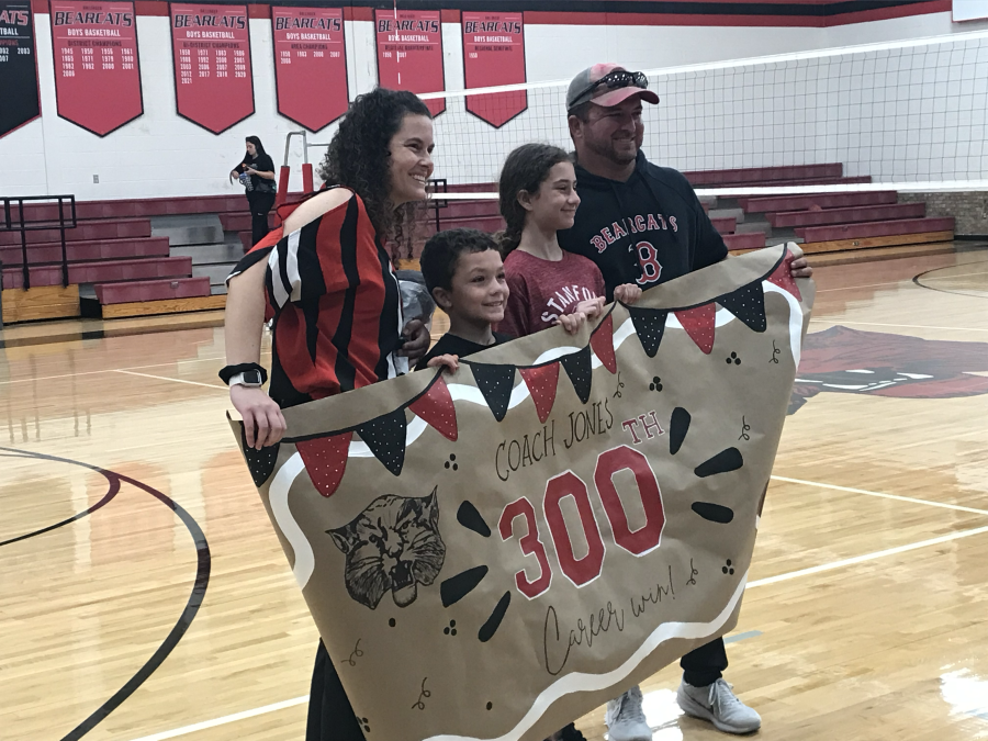 Ballinger head volleyball coach Robynn Jones and her family pose with a banner celebrating her 300th career win Tuesday, Oct. 20, 2026.
