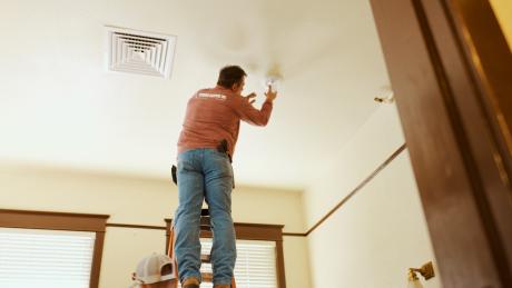 Intrepid Electric's Randy McIntyre installs a light fixture in the historic Railway Museum in San Angelo. LIVE! Photo/Manny Diaz