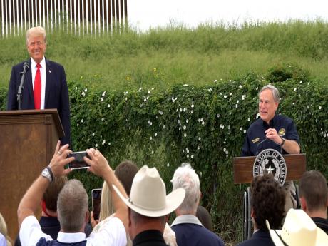 Former President Donald Trump and Texas Governor Greg Abbott at the unfinished border wall in Pharr, Texas.