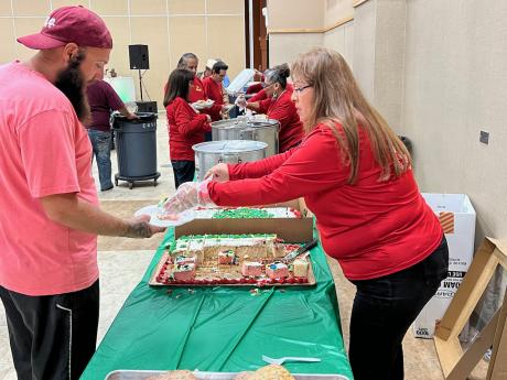 Serving food at the annual Posada on Dec. 10, 2021