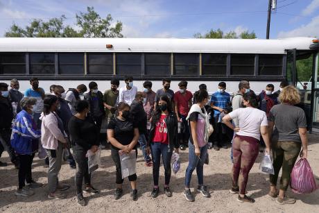 Migrants board a US Border Patrol bus for the detention center on the second day of the implementation of the "Credible Fear and Asylum Processing Interim Final Rule" on June 1, 2022 in La Joya, Texas, USA.