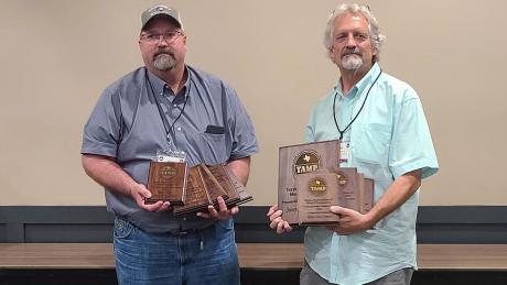 Mark and Paul Sklenarik of Sklenarik's Smoked Meats, Inc. in Miles show off awards won at the 2022 TAMP Convention at Texas A&M University on August 8.
