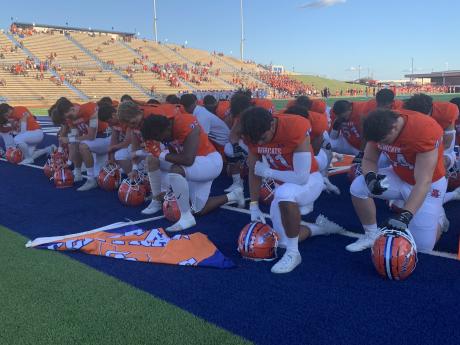 The San Angelo Central Bobcats pray before the game with the Belton Tigers