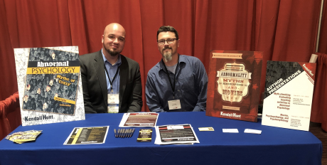 Dr. Drew Curtis (left) presenting his books at a SWPA Conference: