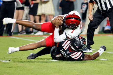 Texas Tech's Donovan Smith is sacked for a loss by North Carolina State's Isaiah Moore during the first half of an NCAA college football game in Raleigh, N.C., Saturday, Sept. 17, 2022. (AP Photo/Karl B DeBlaker)