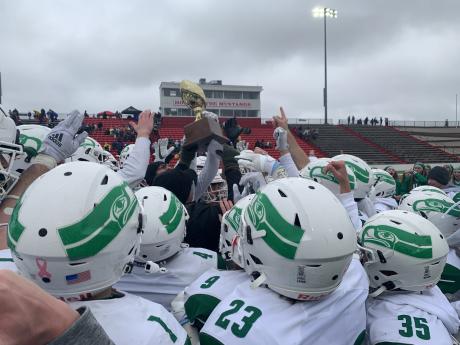 The Wall Hawks holds the trophy for winning the Regional Semi-Finals in the 2022 State Football Playoffs
