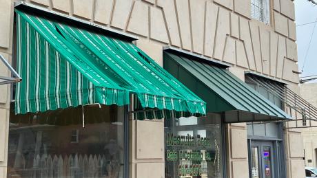 The old awning and a representation of the new steel awnings to be installed soon.