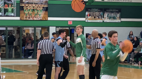 Wall's Everson Armstrong and TLCA's Drew Sherrill take notes from refs before their district game.