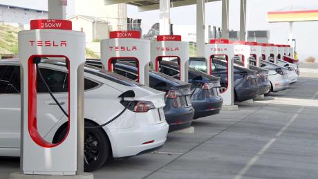 Kettleman City, CA - Jan 29, 2022: Many cars charging at a Tesla Supercharger station. Supercharger stations allow Tesla cars to be fast-charged at the network within a hour.