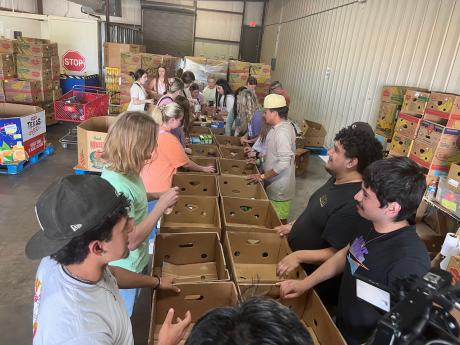 Three sororities and four fraternities sent volunteers from all classes — freshmen through seniors — to help the food bank for three hours on a Thursday evening.