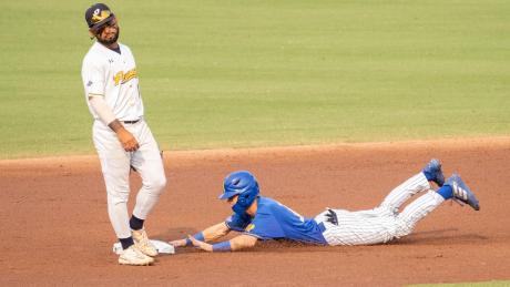 Jackson Hardy dives for the base.