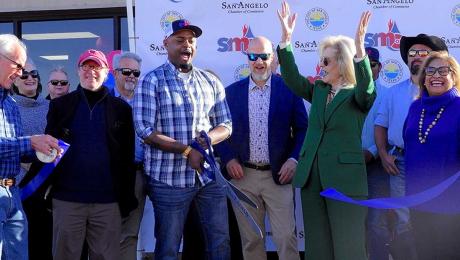Mayor Brenda Gunter (center in green) celebrates the ribbon cutting of the new SMC expanded facility. 
