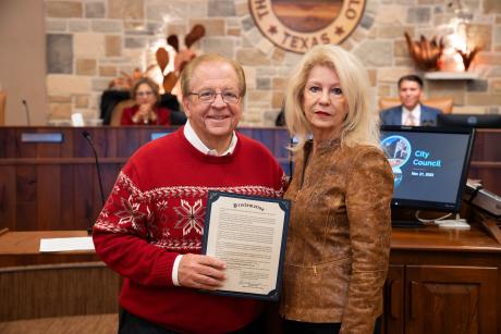 Lee Pfluger (L) and Mayor Brenda Gunter, the Titans of Downtown San Angelo, come together to announce the Proclamation of December 2, 2023 as Concho Christmas Celebration Day.