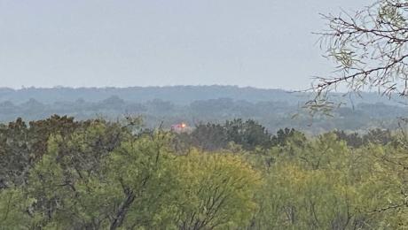 A San Angelo Fire & Rescue EMS ambulance at the crash scene far off in the distance.