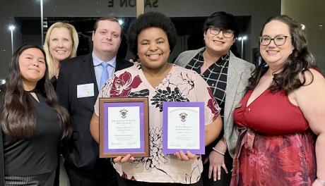 Daysha Johnson (center) with Delta Sigma Pi officials and her awards: