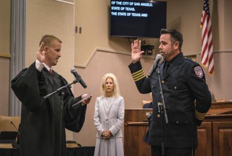 Travis Griffith is sworn in as police chief in late June 2024 by County Judge Lane Carter as Mayor Brenda Gunter looks on. 