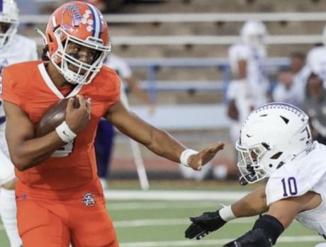 San Angelo Central quarterback Christian English tries to evade a defender in a game against Midland High in 2023.
