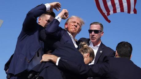 Donald Trump fist bumps as he is escorted off the grandstand during a rally where shots rang out in Butler, PA on July 13, 2024 at 5:13 p.m. CDT.