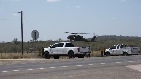 The National Guard joined in the effort to fight wildfires outside Mason on Friday afternoon by deploying helicopters, including one loaded with water to drop on the fires.