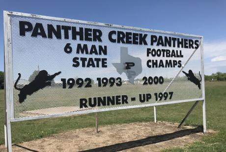 A sign at Panther Creek High School displays the football program's accomplishments.