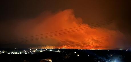 Numerous fire departments have been battling a wildfire less than 10 miles east of the small Hill Country town of Mason.