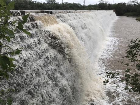 Water from Elm Creek rushes over the dam at Ballinger's City Park on Tuesday, Sept. 3, 2024, after heavy rains in the area.
