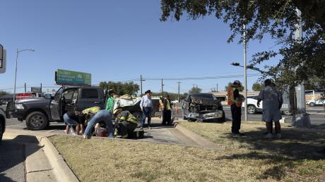 First responders assess the scene after two Dodge Ram pickups collided near the intersection of North Taylor Street and Sherwood Way. One of the trucks sustained heavy front-end damage, while no serious injuries were reported.