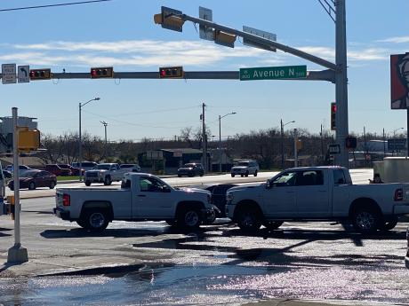 A crash involving two white pickup trucks and a black sedan temporarily closed the intersection of Avenue N and South Bryant Boulevard Sunday morning.