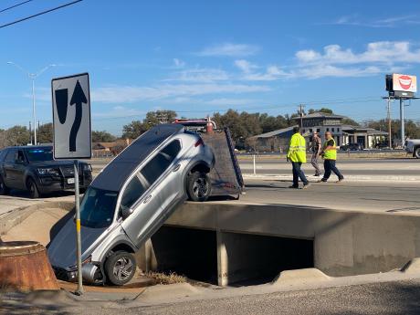At one location, a vehicle ended up partially lodged in a drainage ditch along the Loop 306 frontage road.