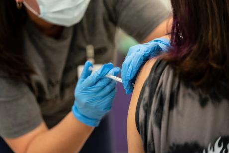A nurse administers a dose of the Pfizer COVID vaccine at a clinic organized by the Travis County Mobile Vaccine Collaborative at Rodriguez Elementary School on July 28, 2021.
