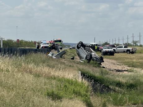 A car flipped onto its roof after slamming into a guardrail outside Carlsbad Monday afternoon.
