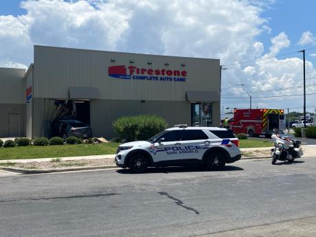 At least two people were taken to the hospital Wednesday afternoon after a car crashed through the Firestone Complete Auto Care building on Knickerbocker Road.