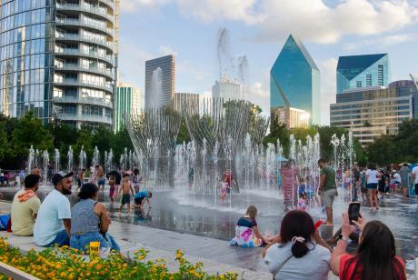 Children play at the Nancy Best Fountain at Klyde Warren Park in downtown Dallas on July 27. The City Council voted this week to end diversity initiatives to keep federal funding.