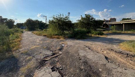 The overgrown site of the former Beaver Lodge Motel at 405 S. Chadbourne St., just south and west of the Chadbourne St. bridge over the Concho River. 