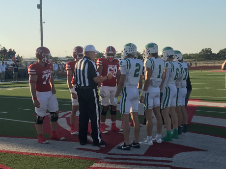 Captains for the Wall Hawks and Jim Ned Indians meet at midfield for the coin toss before their football game Friday, Sept. 12, 2025.