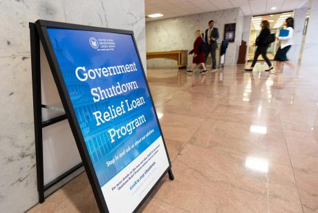 A sign advertises a government shutdown relief loan program outside the United States Senate Federal Credit Union branch office in the Hart Senate Office Building in Washington on Tuesday, Sept. 30, 2025.