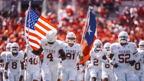 The Texas Longhorns football team runs onto the field before a game during the 2025 season.