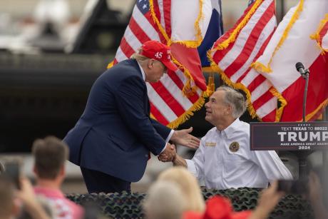 President Donald Trump greets and shakes hands with Gov. Greg Abbott in Edinburg on Nov. 19, 2023. Trump on Tuesday endorsed Abbott, who is seeking a fourth term as Texas governor.  Eddie Gaspar/The Texas Tribune