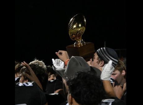 The Water Valley Wildcats hoist a bidistrict playoff trophy after their 62-14 win over Hermleigh on Thursday, Nov. 13, 2025.