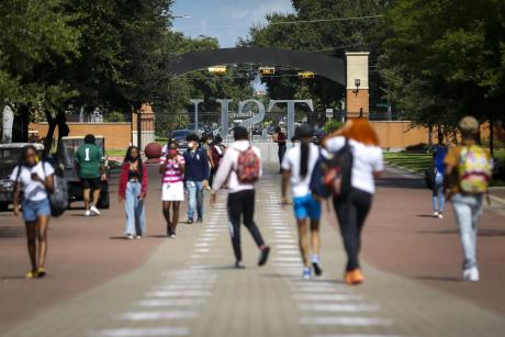 Students walk along the Tiger Walk through campus on the first day of class at Texas Southern University on Monday, Aug. 23, 2021.