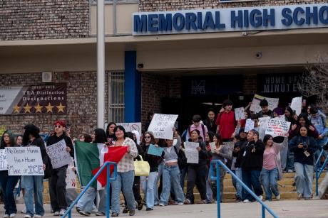 Students from San Antonio's Memorial High School walk out in protest against Immigration and Customs Enforcement (ICE) on Jan. 30, 2026. School staff and Edgewood ISD police officers blocked access to public sidewalks and the road in front of the campus saying that school property was extended for student safety. Students were directed back to class after the brief demonstration.