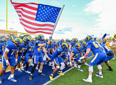 The Angelo State football team prepares to run onto the field before a game during the 2025 season.
